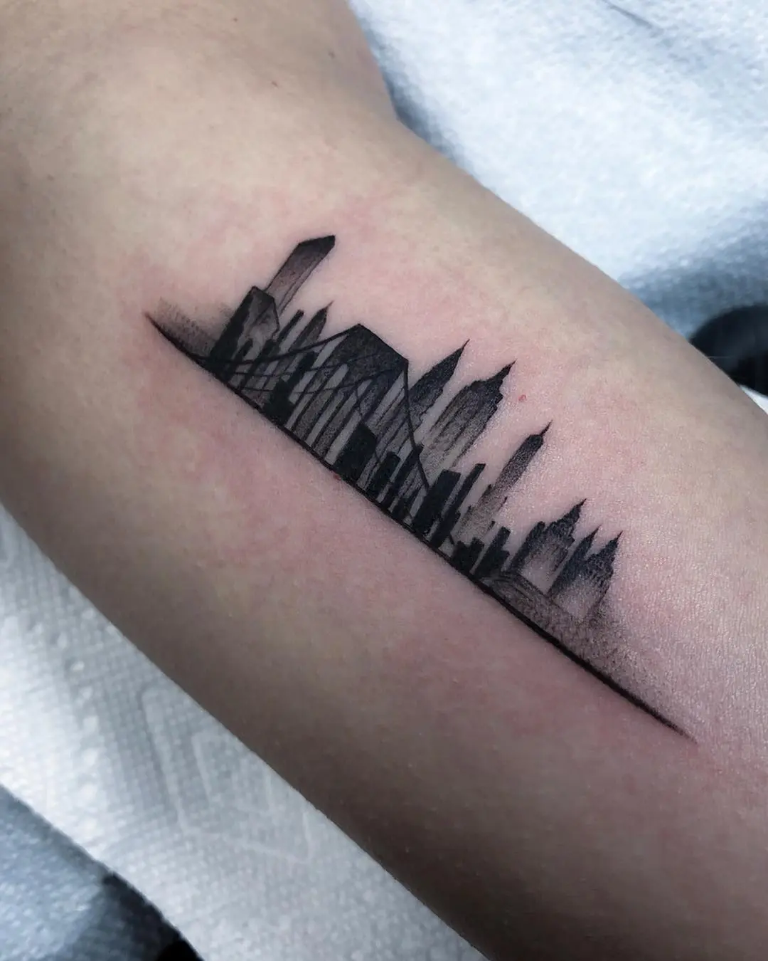 Elegant skyline tattoo with minimalist design
