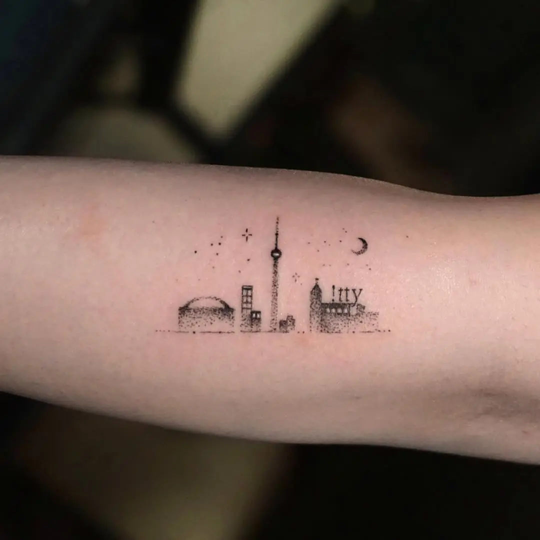 Charming minimalist Toronto skyline tattoo design