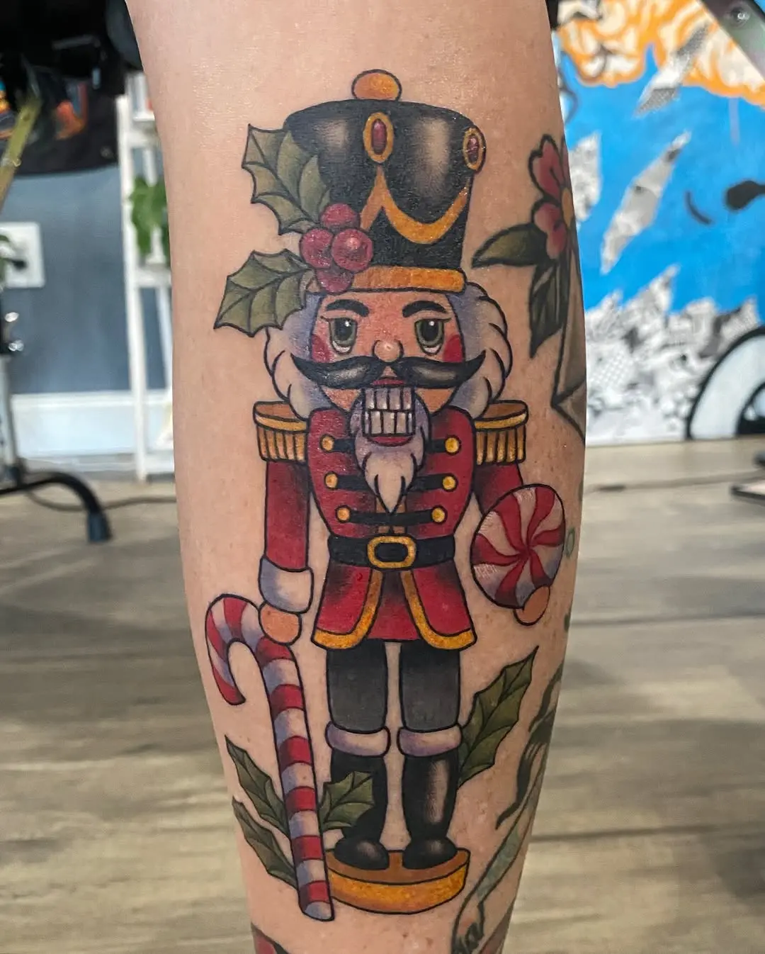 Festive nutcracker tattoo with candy cane detail
