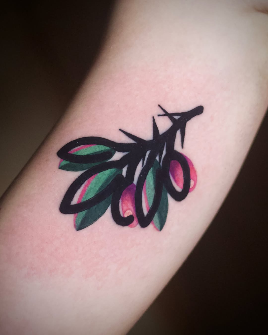 Elegant olive branch tattoo with vibrant colors