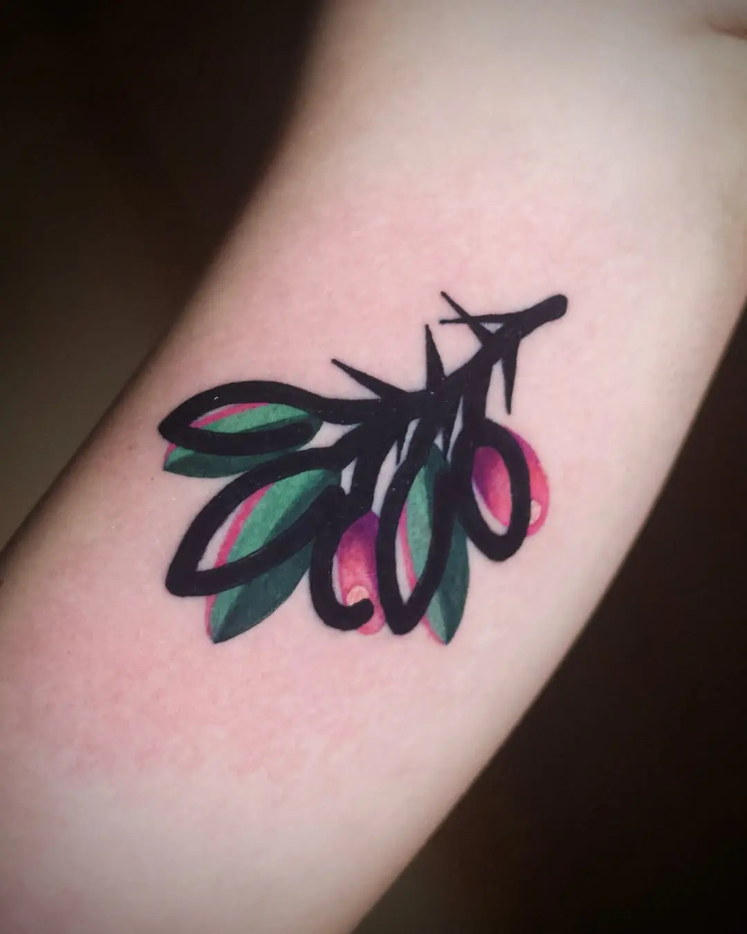 Elegant olive branch tattoo with vibrant colors