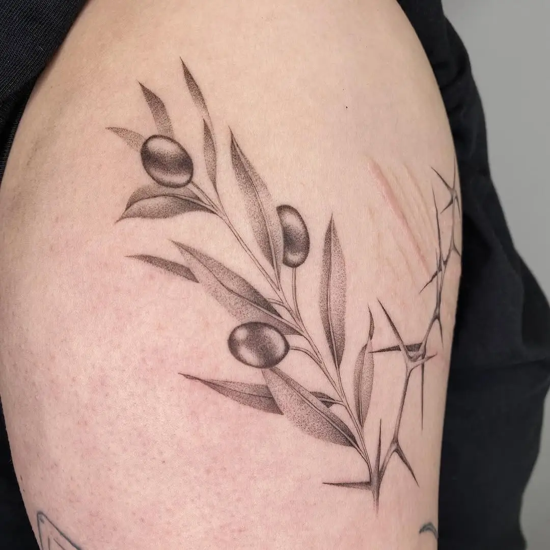 Intricate olive branch tattoo design on arm