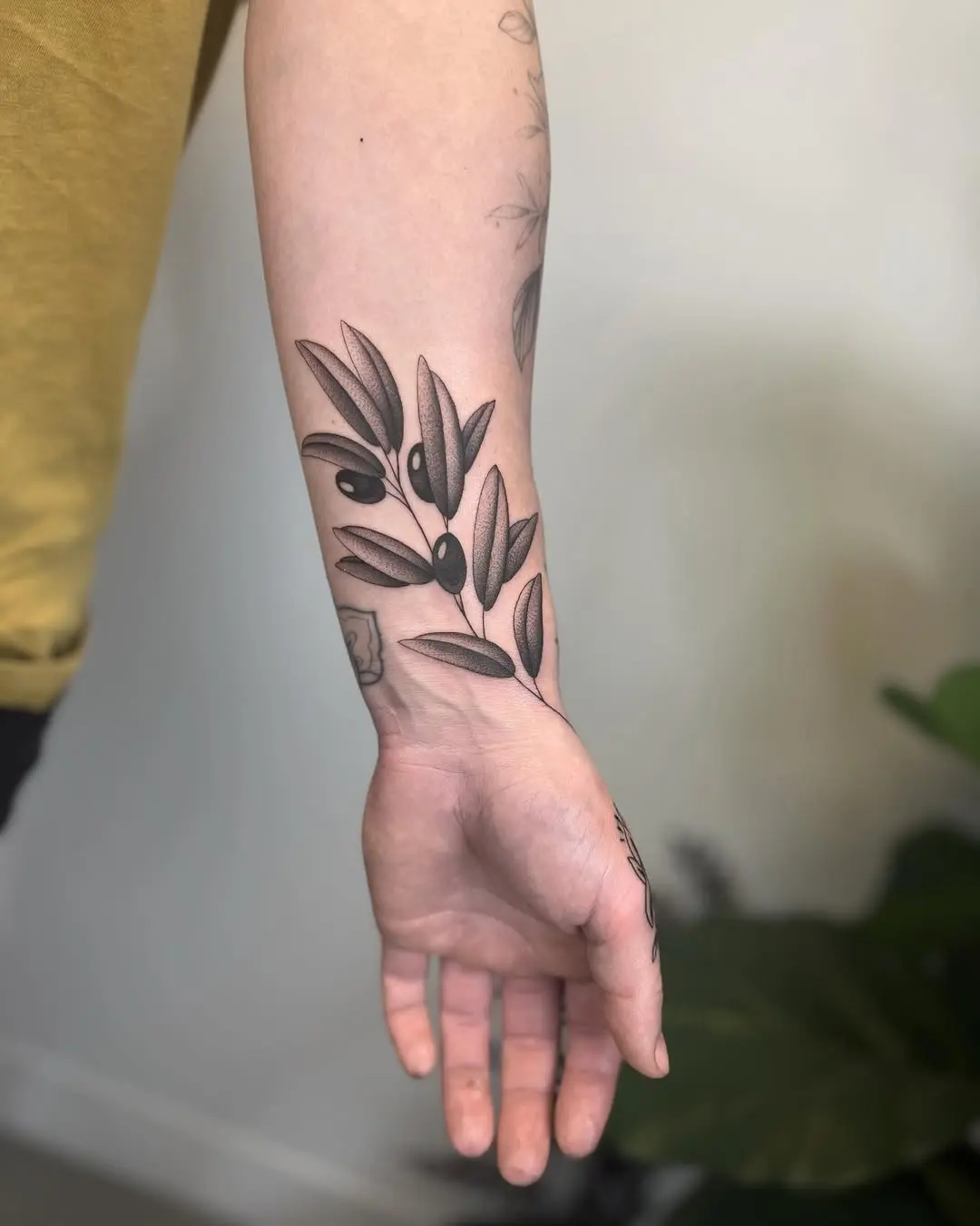 Elegant Black Olive Branch Tattoo Design
