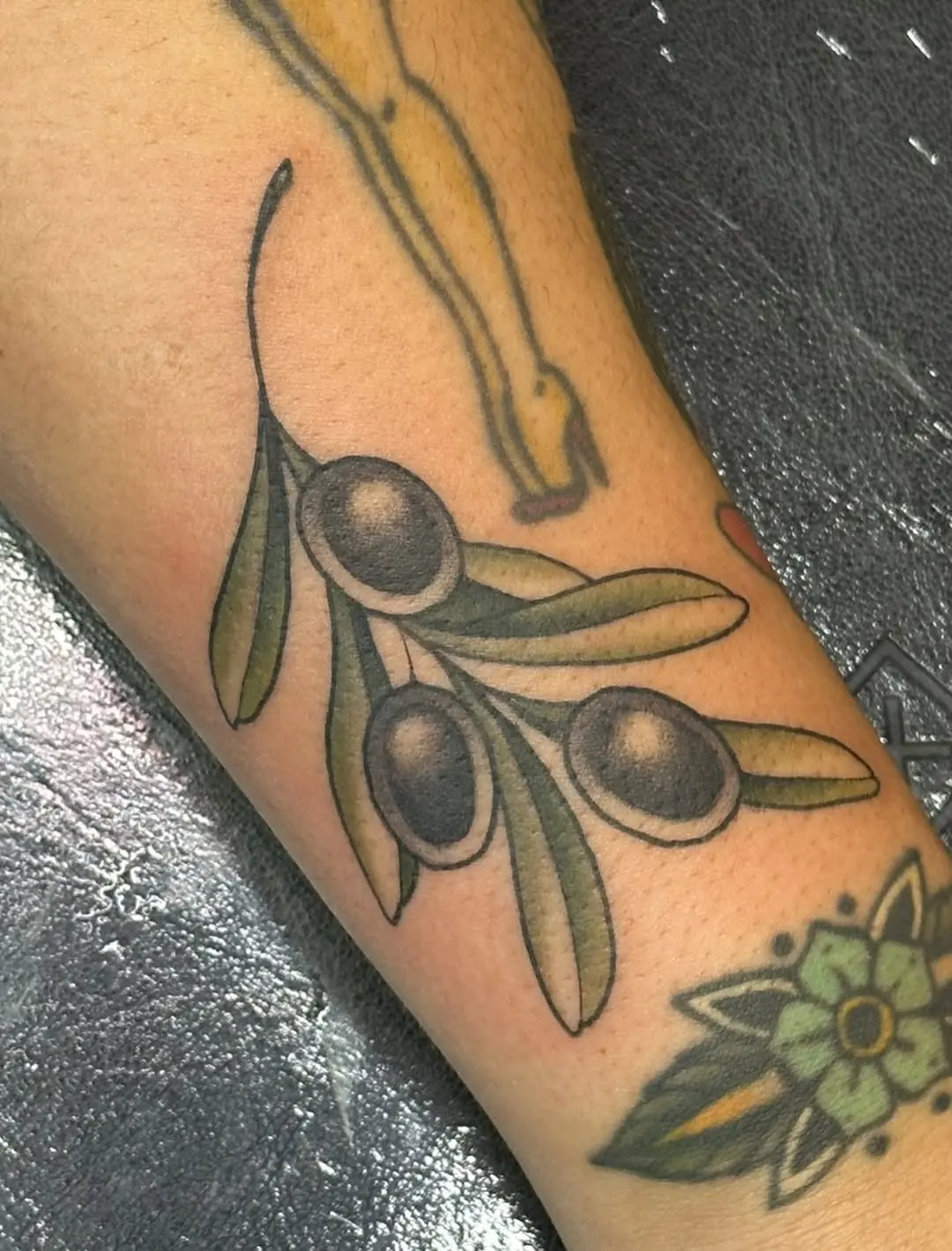 Elegant and symbolic olive branch tattoo design