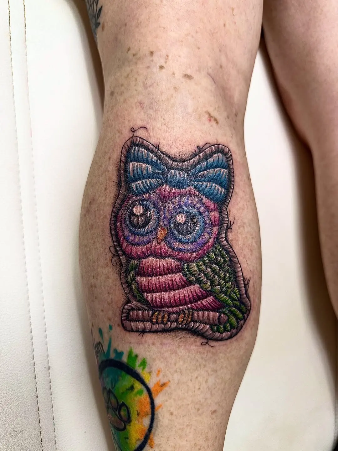 Vibrant owl embroidery tattoo with playful details