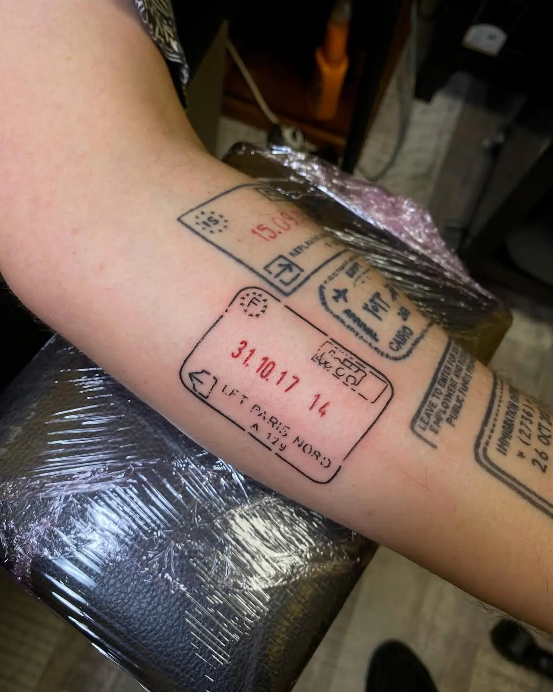 Creative passport stamp tattoo for travel lovers