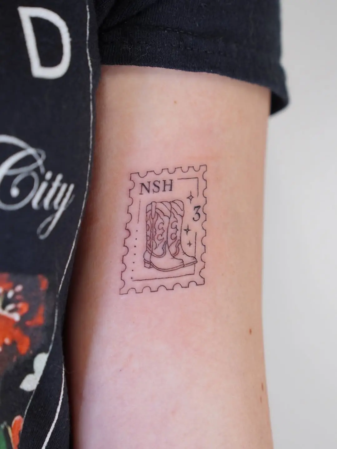 Unique stamp tattoo featuring cowboy boots