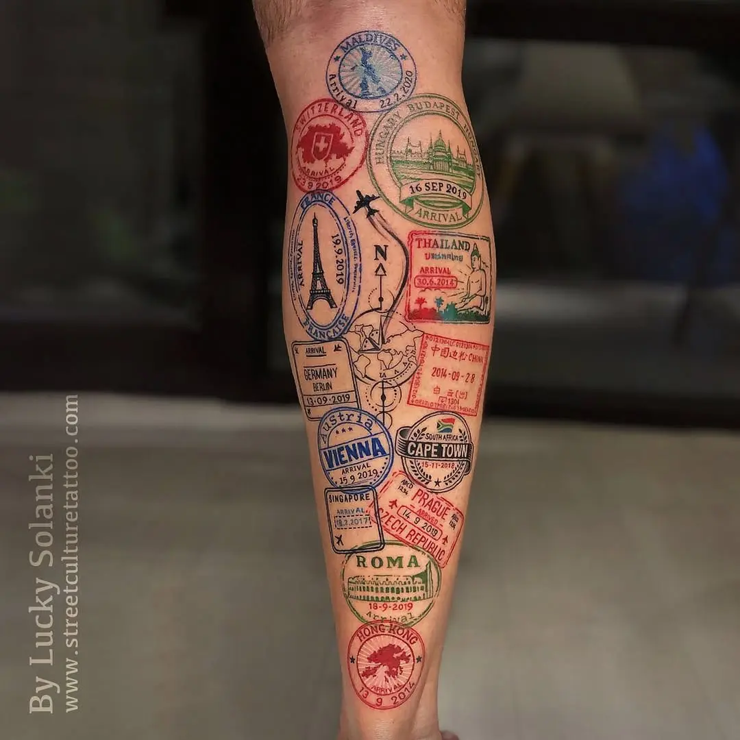 Vibrant travel stamp-inspired leg tattoo design