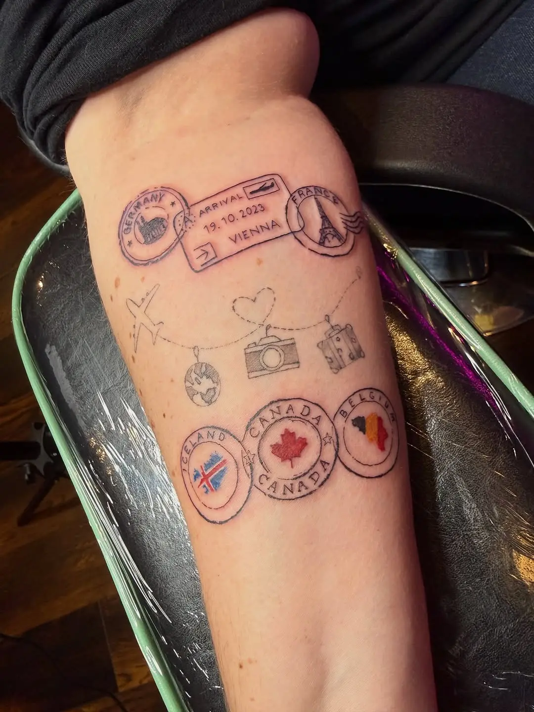 A unique travel stamp-inspired tattoo design
