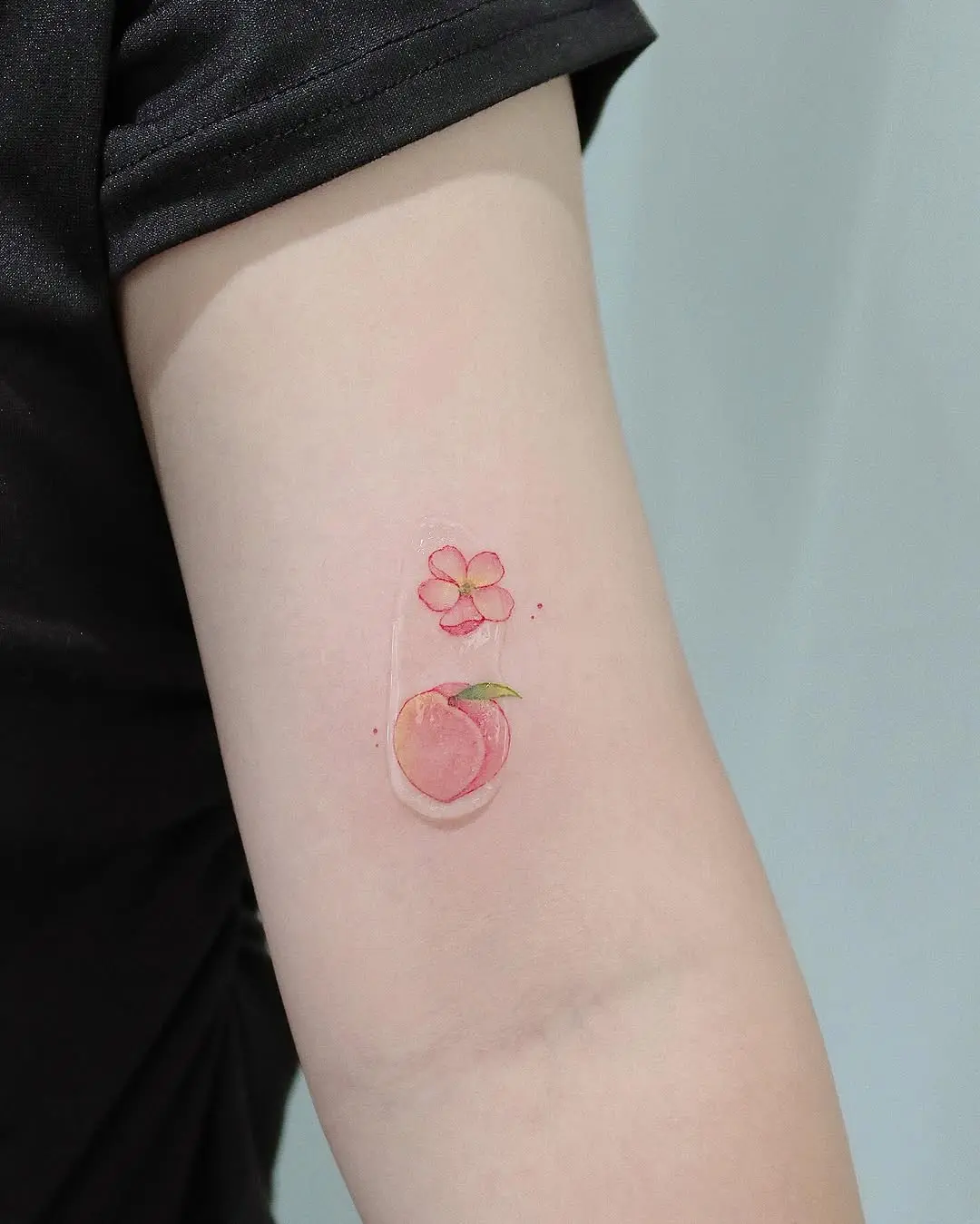 Charming peach and flower tattoo design