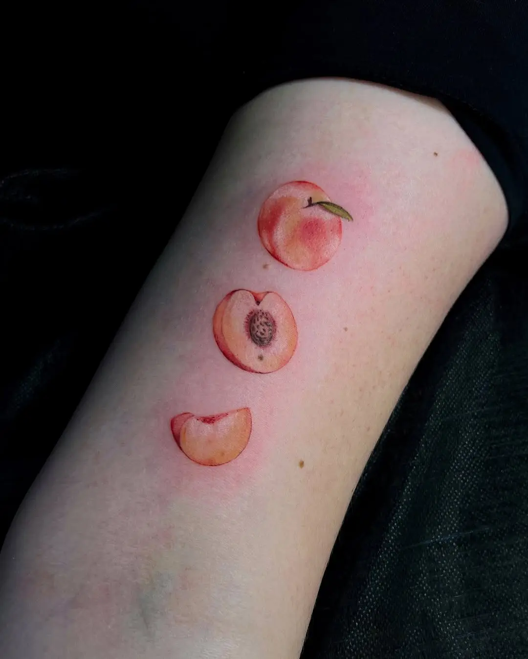 Three Vibrant Peach Tattoos on Display
