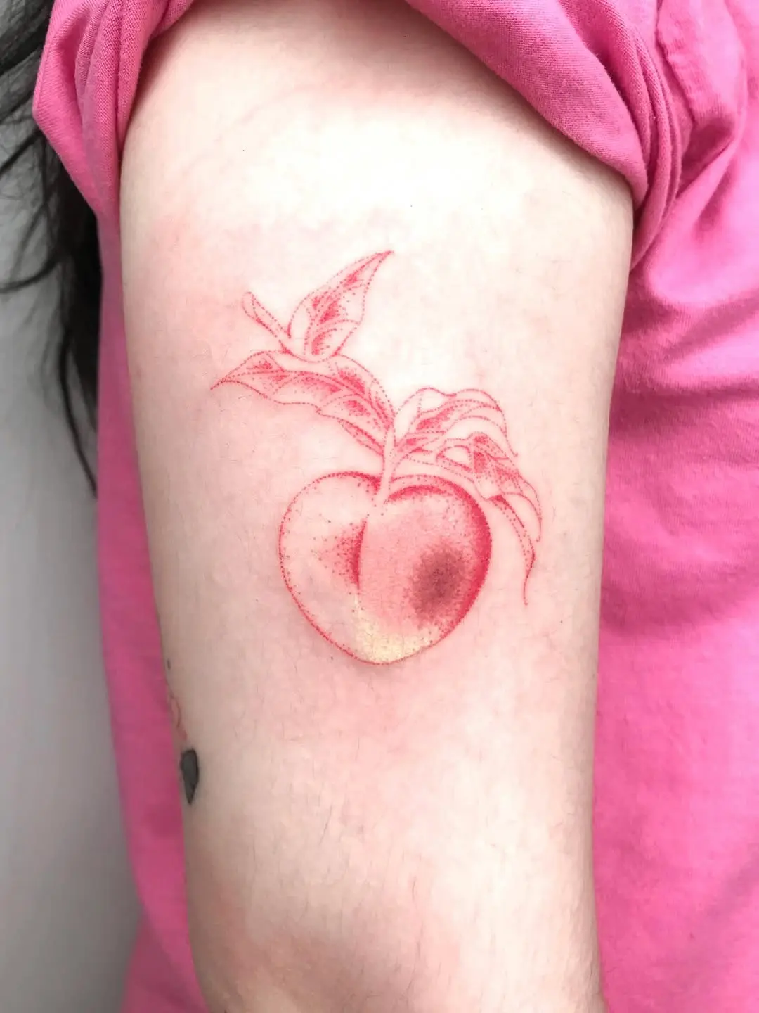 Whimsical peach tattoo with delicate details