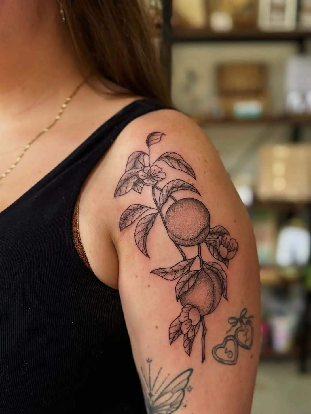 Stylish peach tattoo with floral details