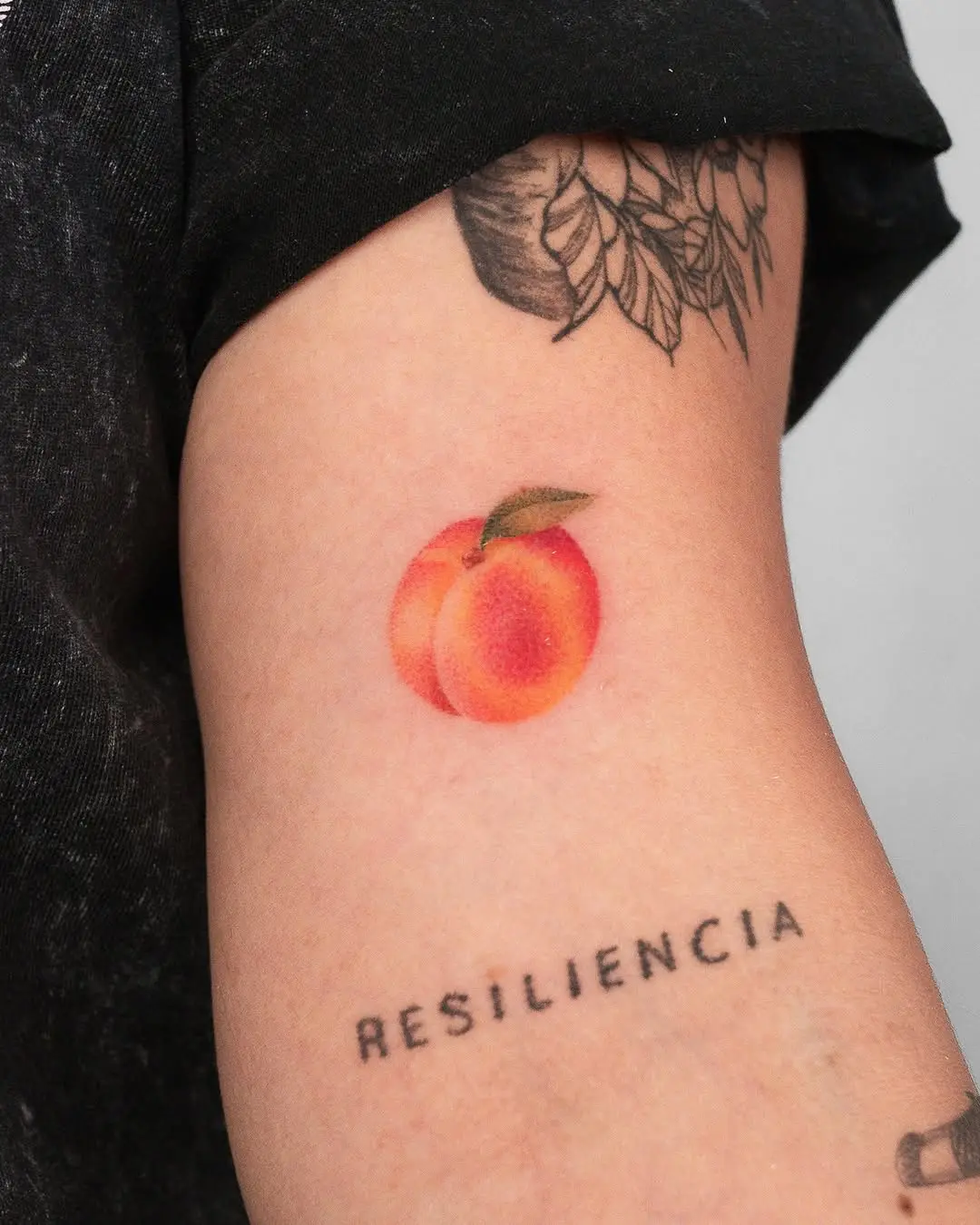 Colorful peach tattoo symbolizing resilience and beauty