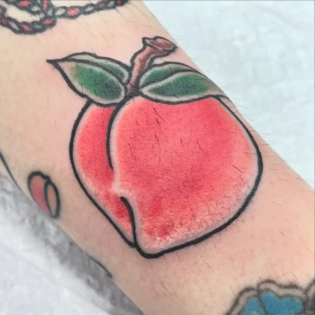 Vibrant peach tattoo capturing playful artistry