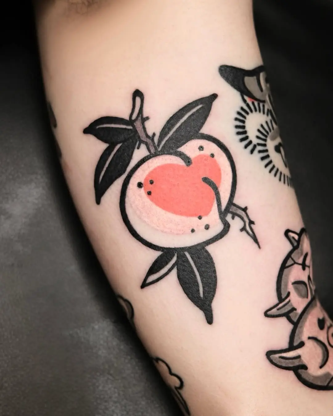 Bright peach tattoo with leafy details