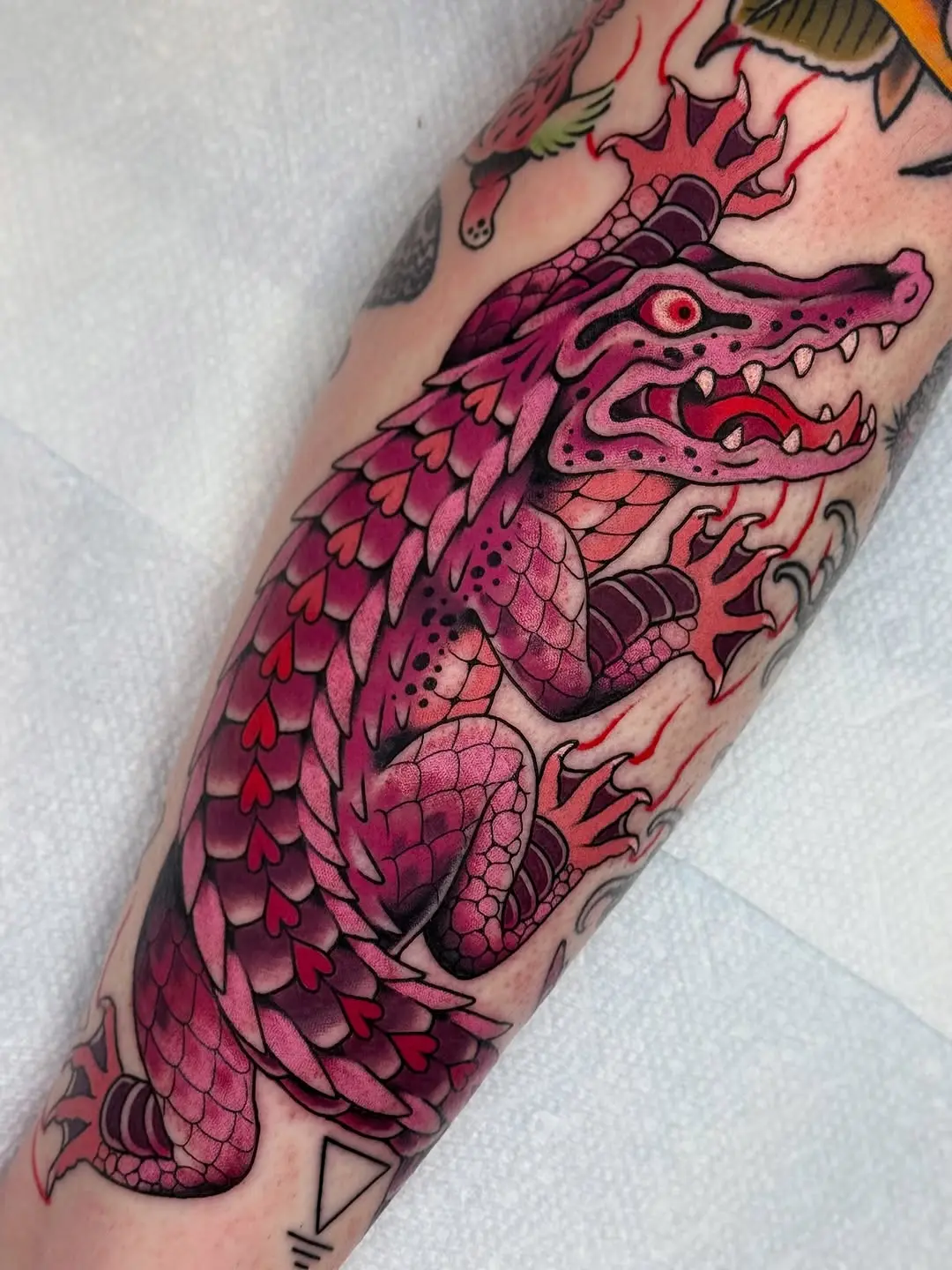 Vibrant pink dragon tattoo with dynamic details