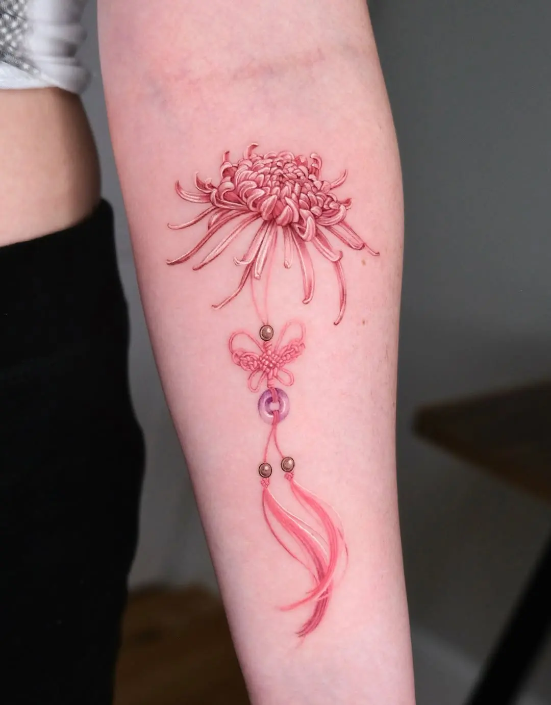 Delicate pink floral and butterfly tattoo design