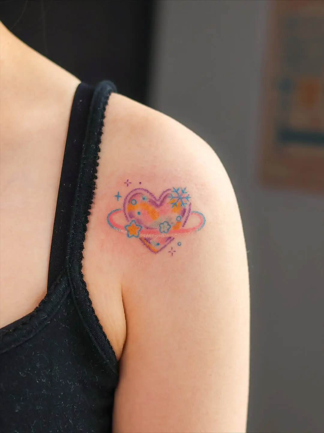 Colorful heart tattoo with cosmic elements