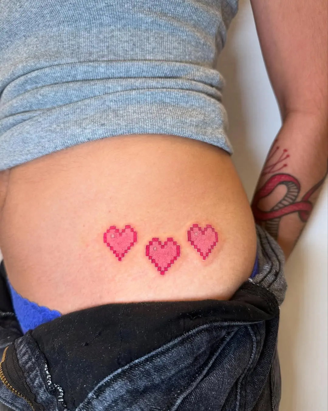 Charming pixel heart tattoos on the skin