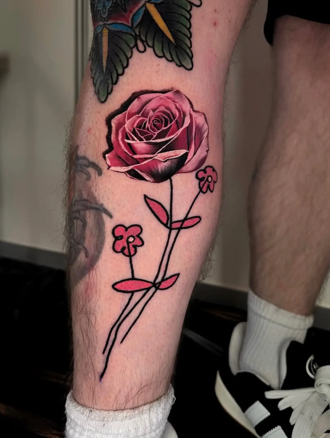 Beautiful pink rose tattoo on leg