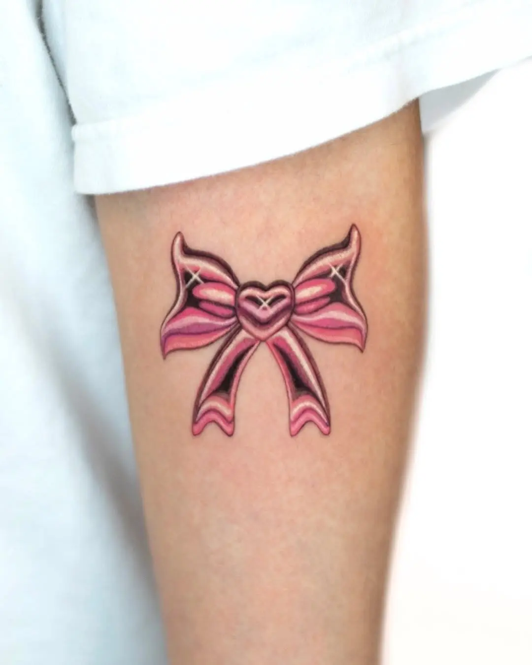 Charming pink bow tattoo with heart detail