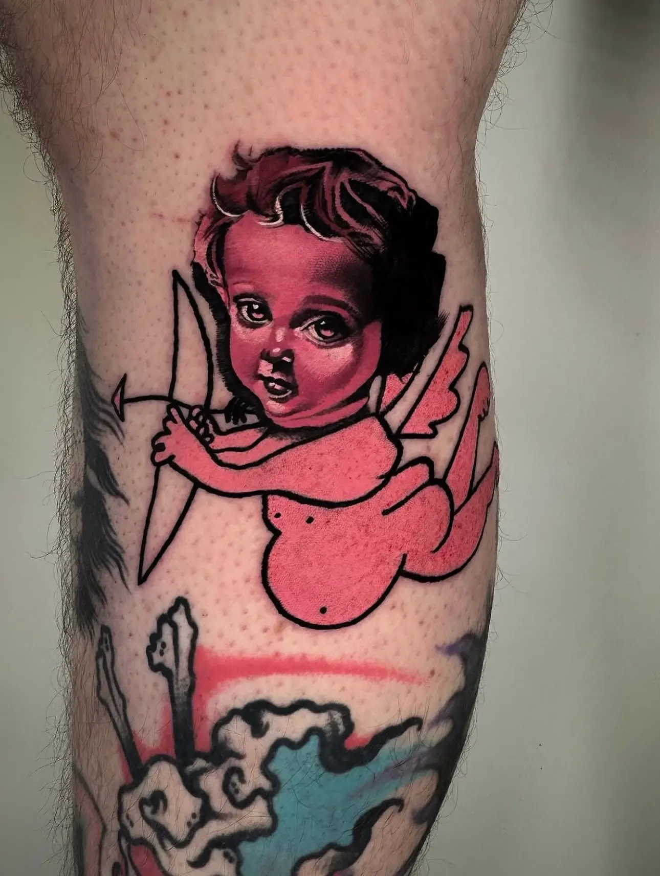Charming cherub tattoo in soft pink hues