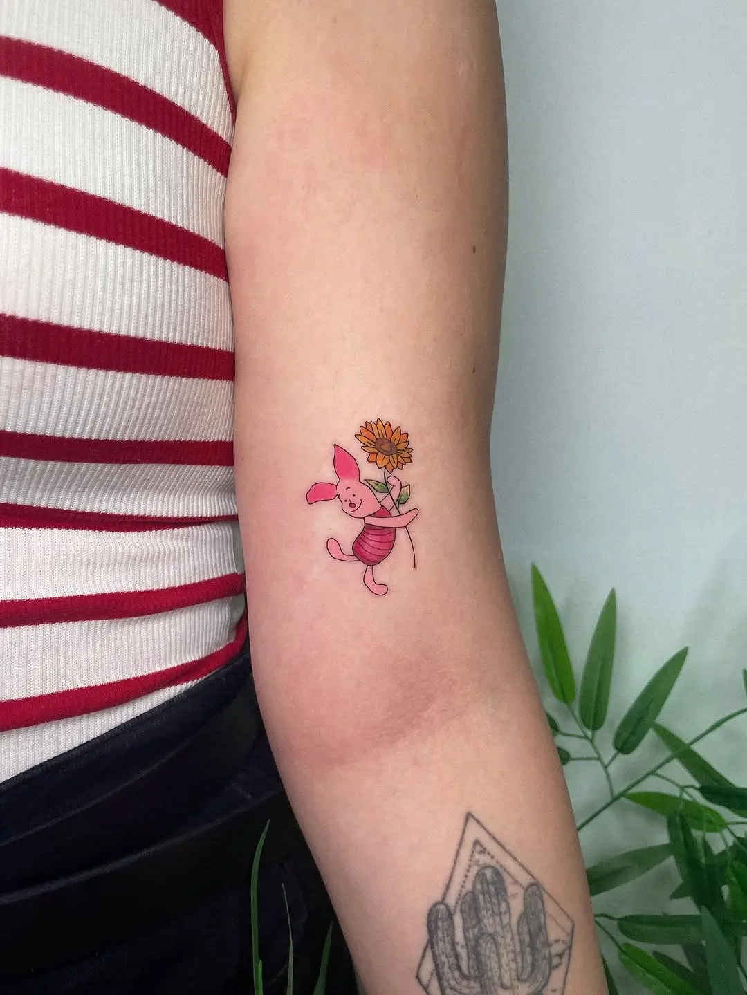 Charming pink pig tattoo with sunflower detail