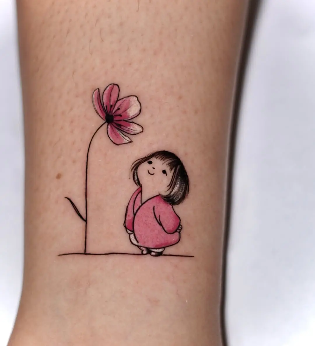 Charming pink flower with playful girl tattoo