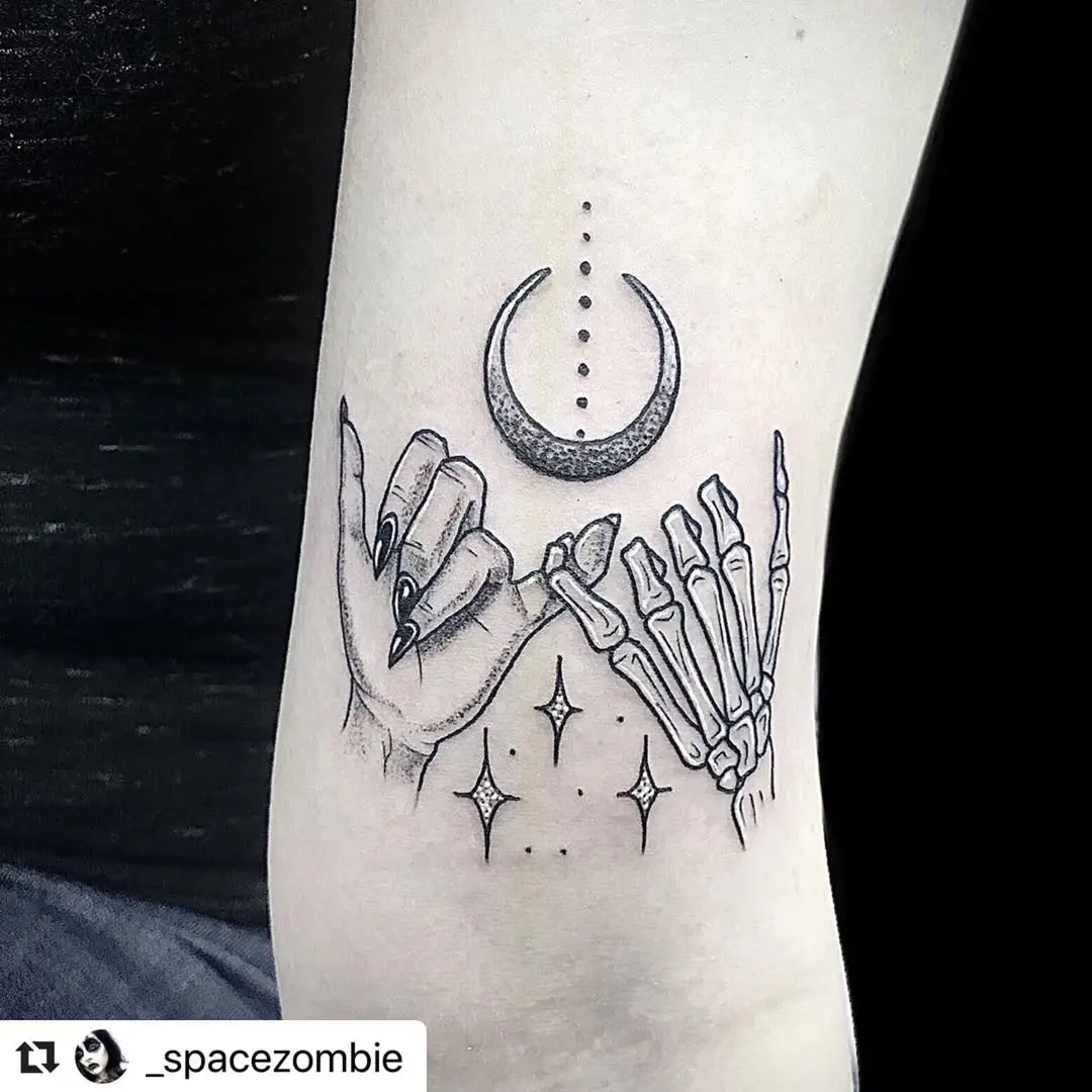 Skeleton hands making a pinky promise tattoo