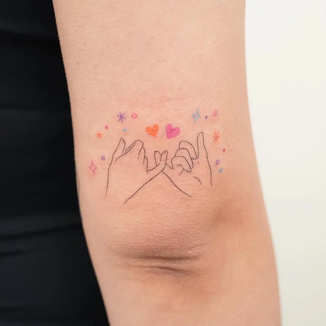 Colorful pinky promise tattoo showcasing friendship