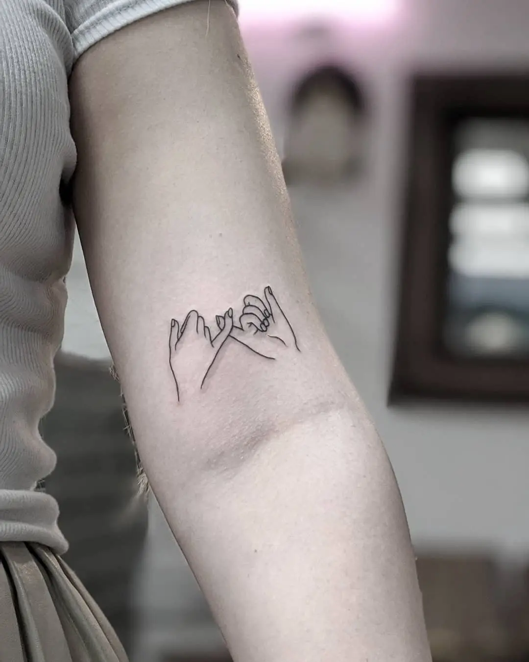 Meaningful pinky promise tattoo design