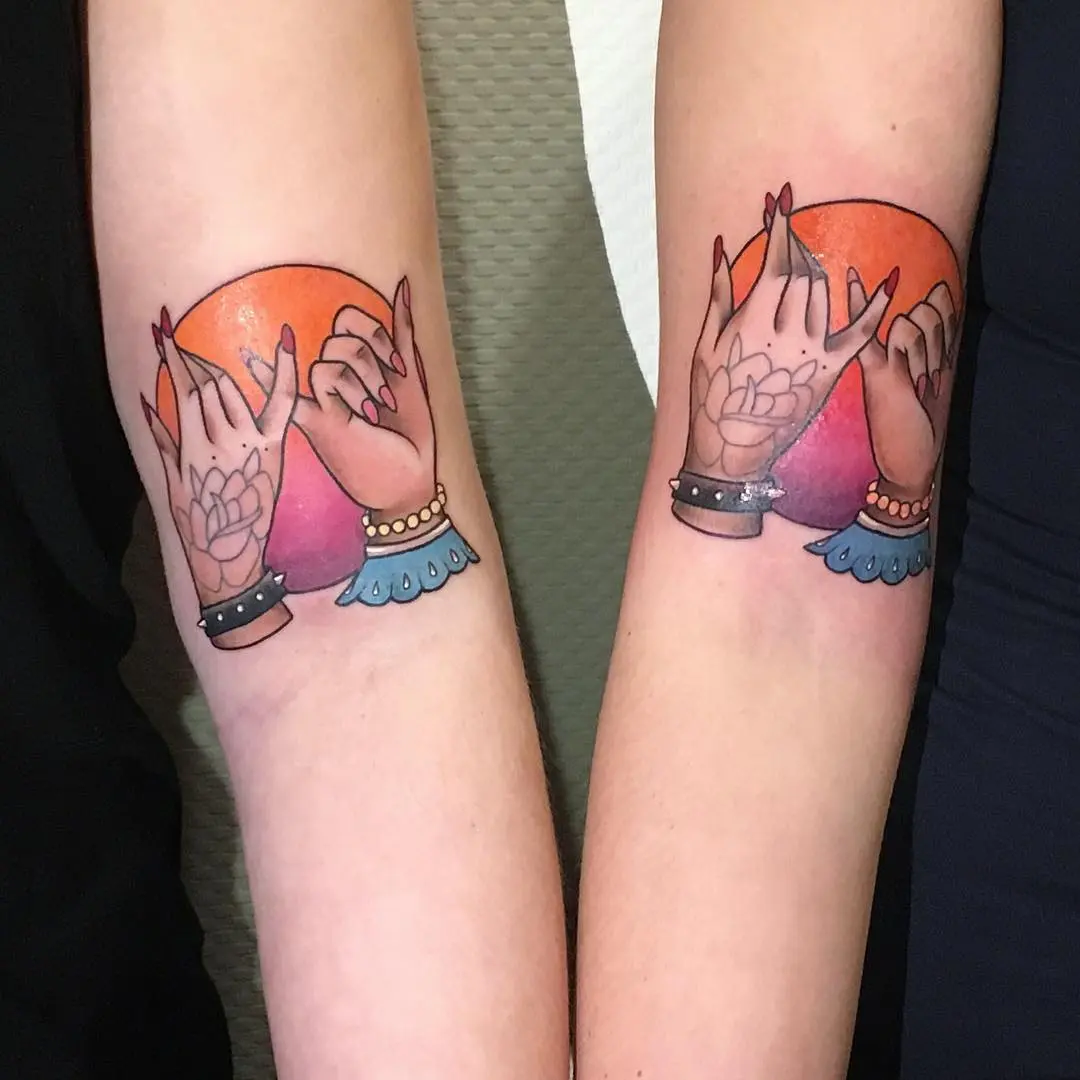 Charming pinky promise tattoos with sunset backdrop