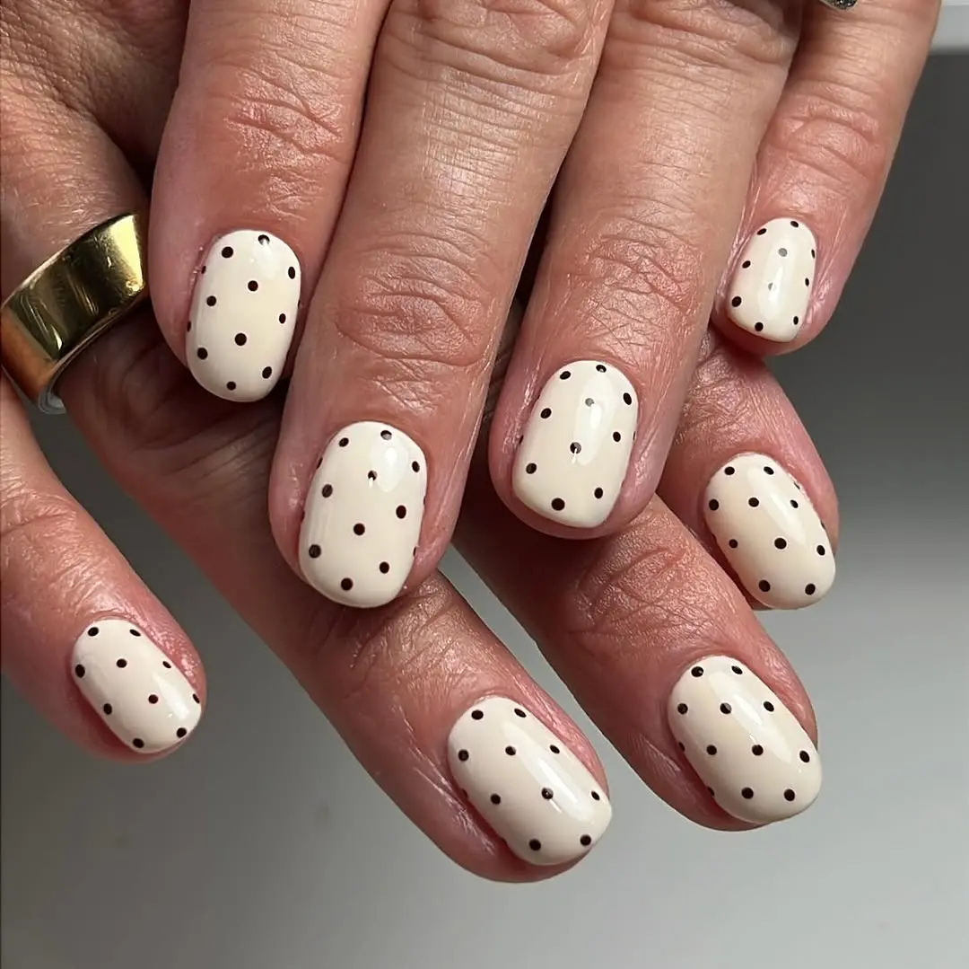 Chic beige nails with brown polka dots