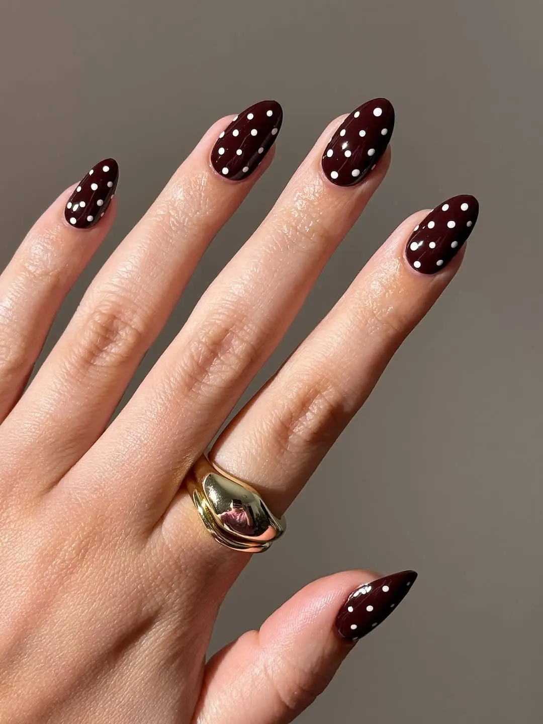 Chic burgundy polka dot nail design