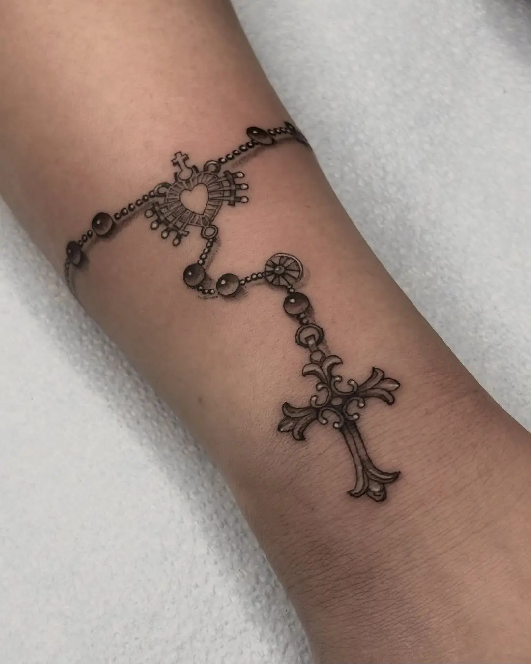 Elegant rosary tattoo with intricate details
