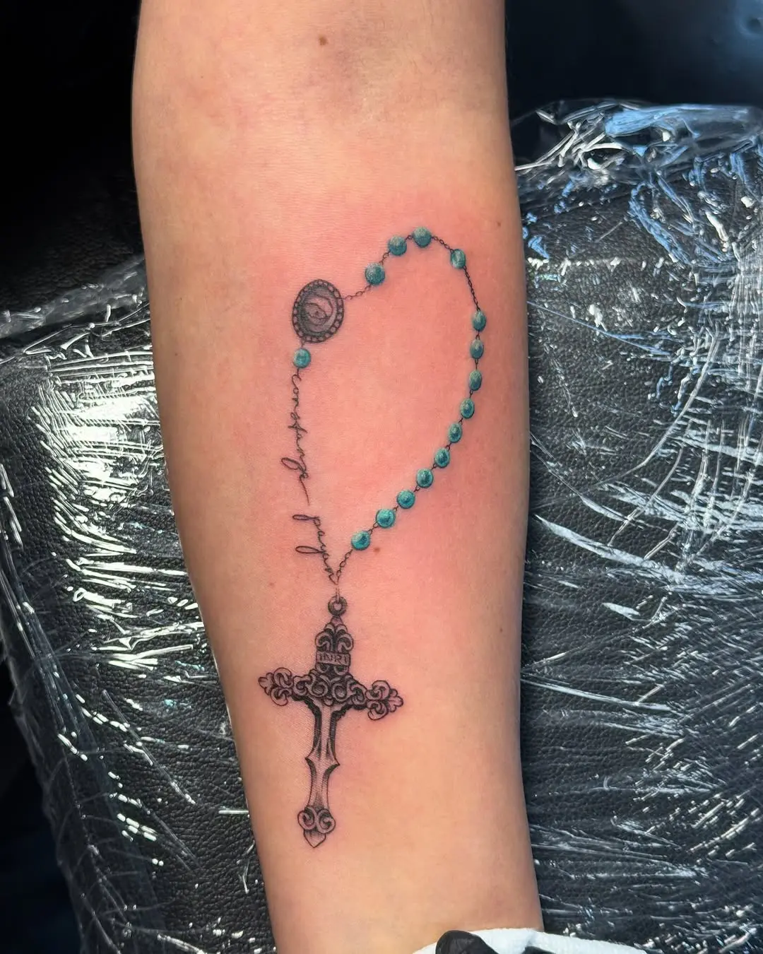 Elegant rosary tattoo with vivid turquoise beads
