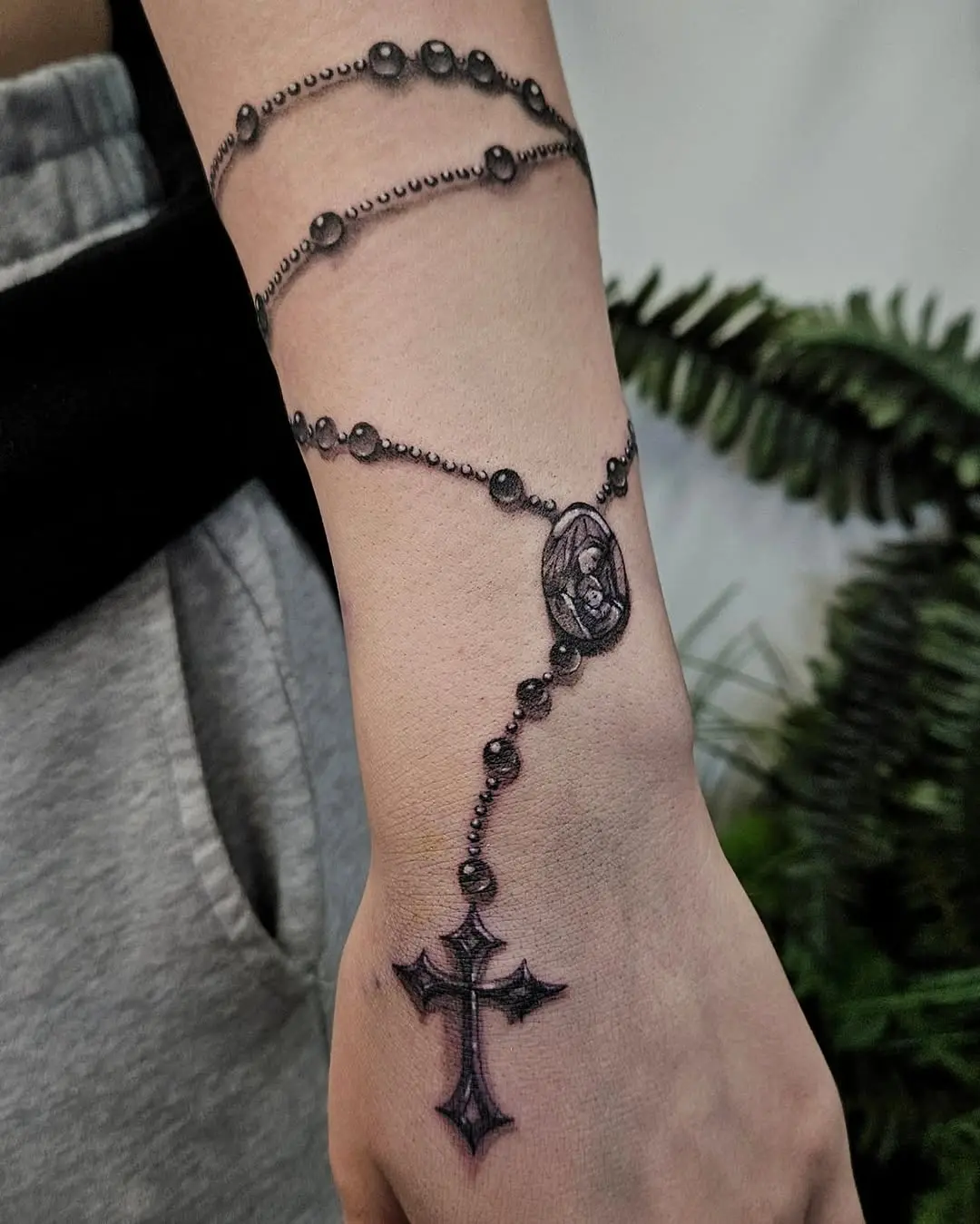 Elegant Rosary Tattoo Adorning the Arm