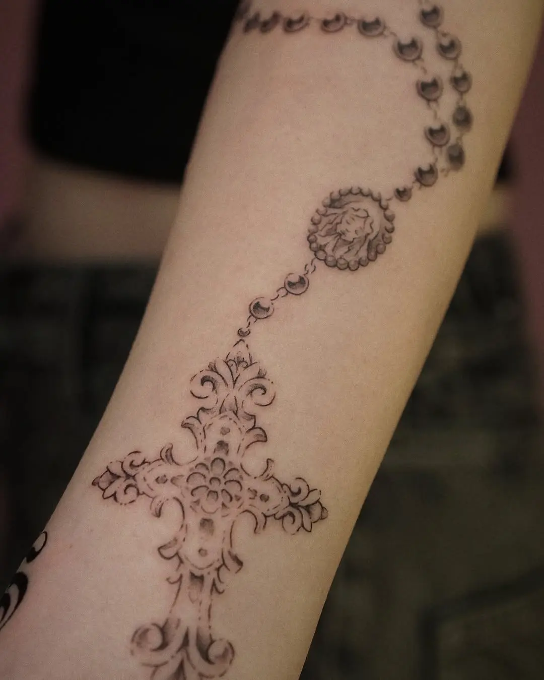 Intricate rosary tattoo with elegant detailing