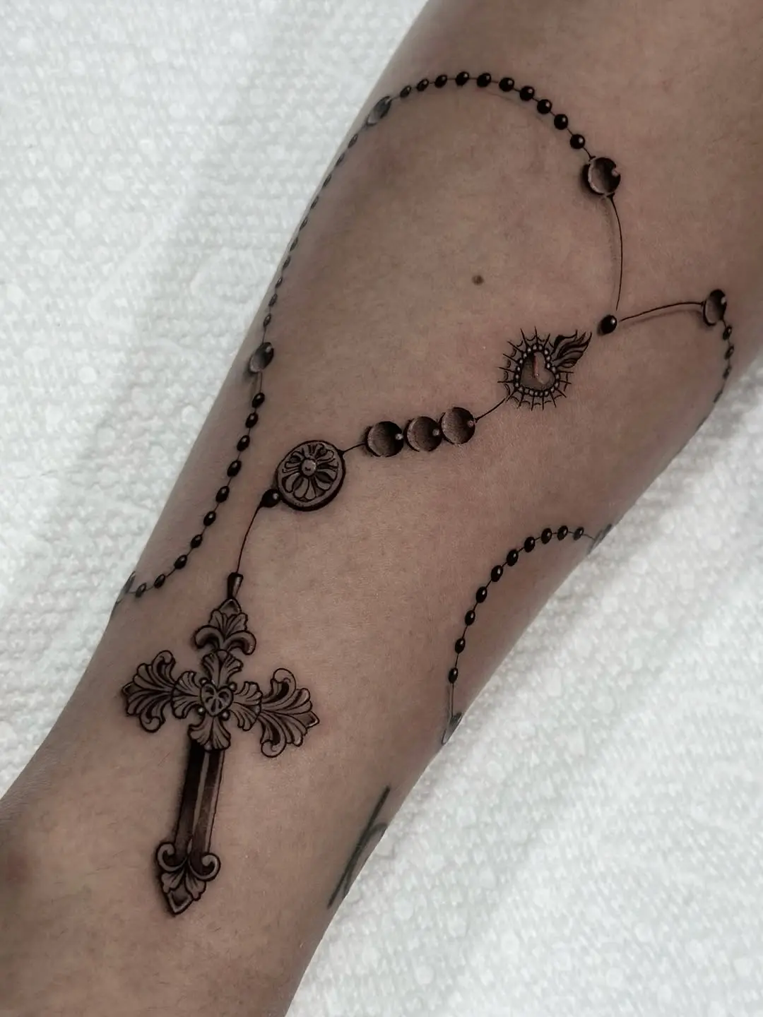 Elegant rosary tattoo showcasing intricate details