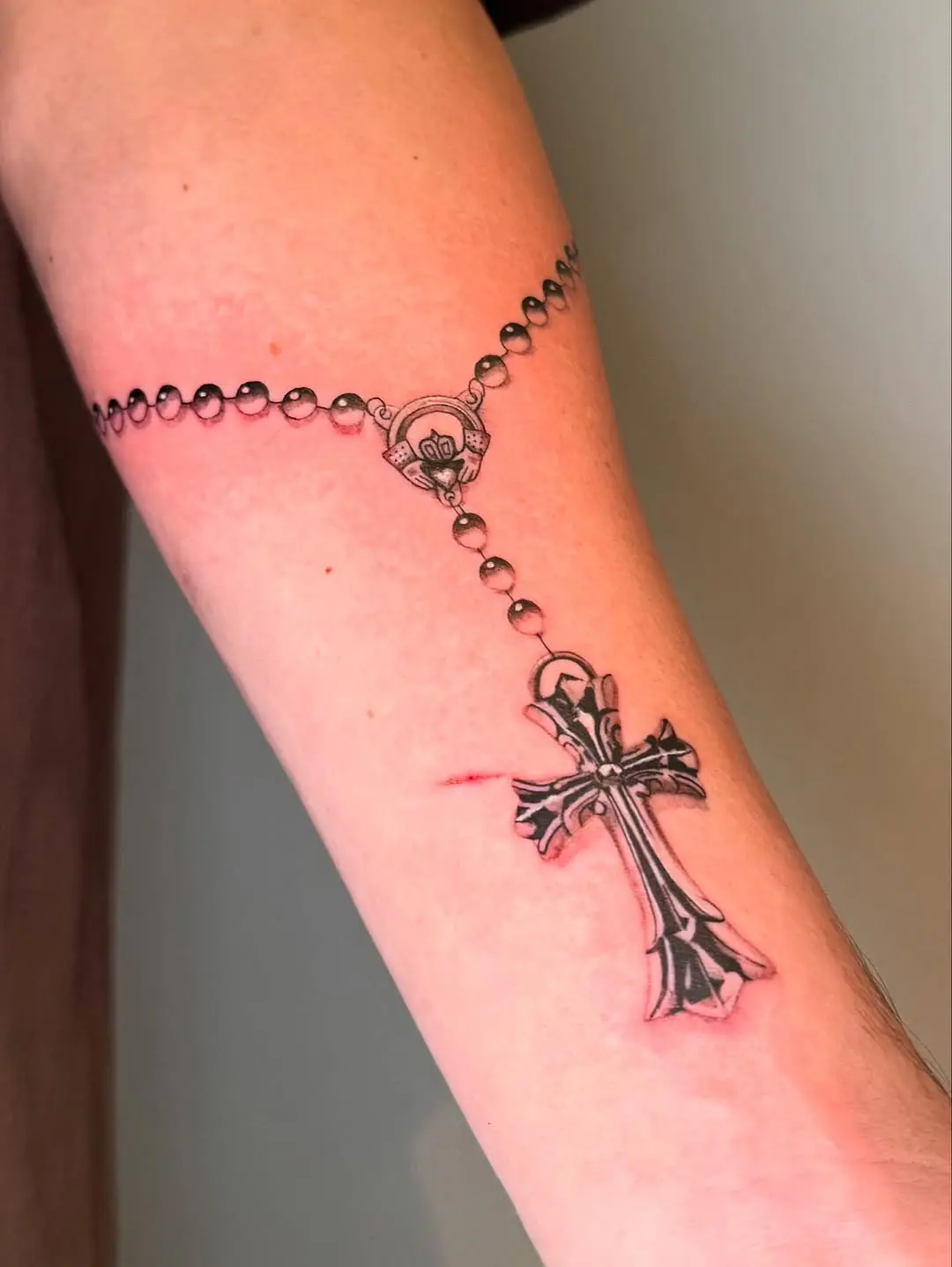 Stunning rosary tattoo with intricate cross design