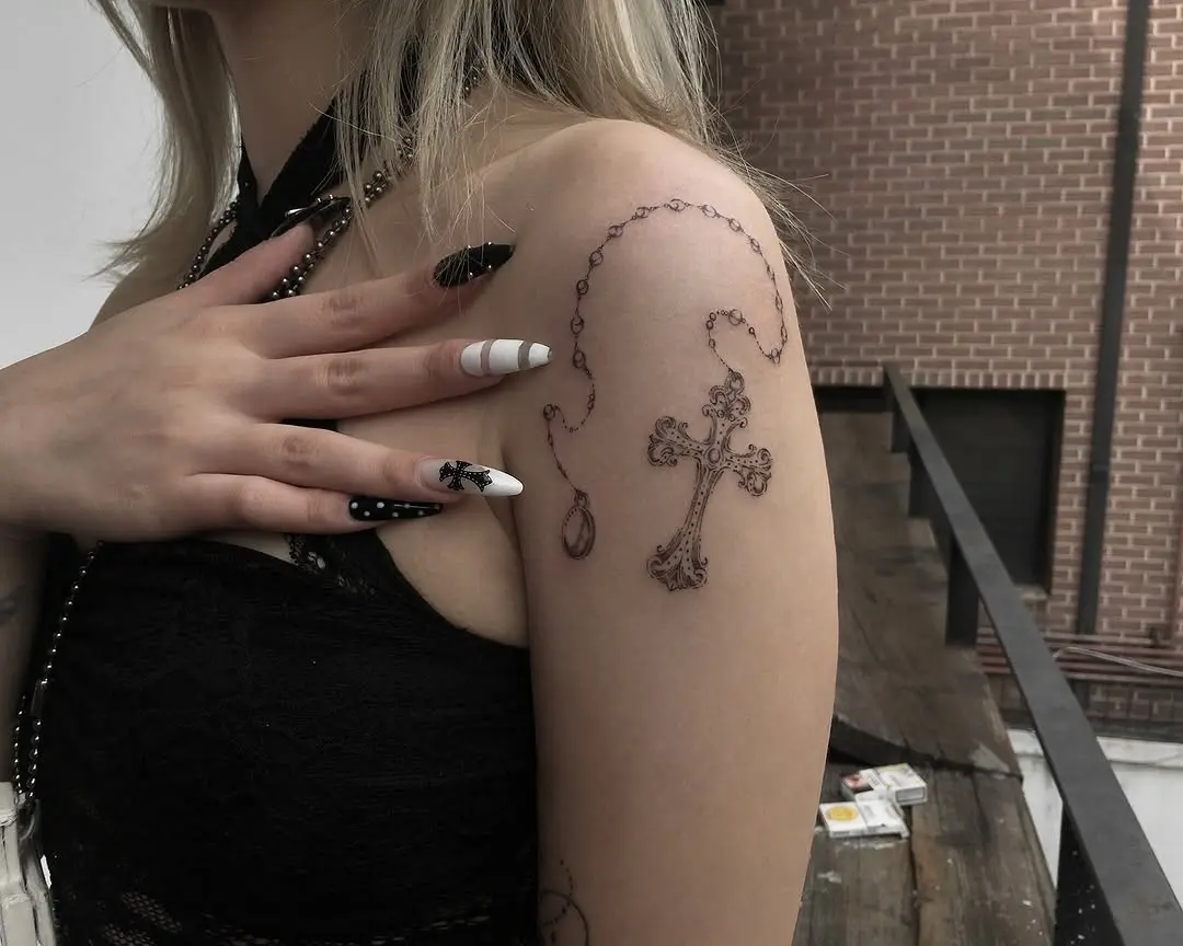 Delicate rosary tattoo with intricate cross design