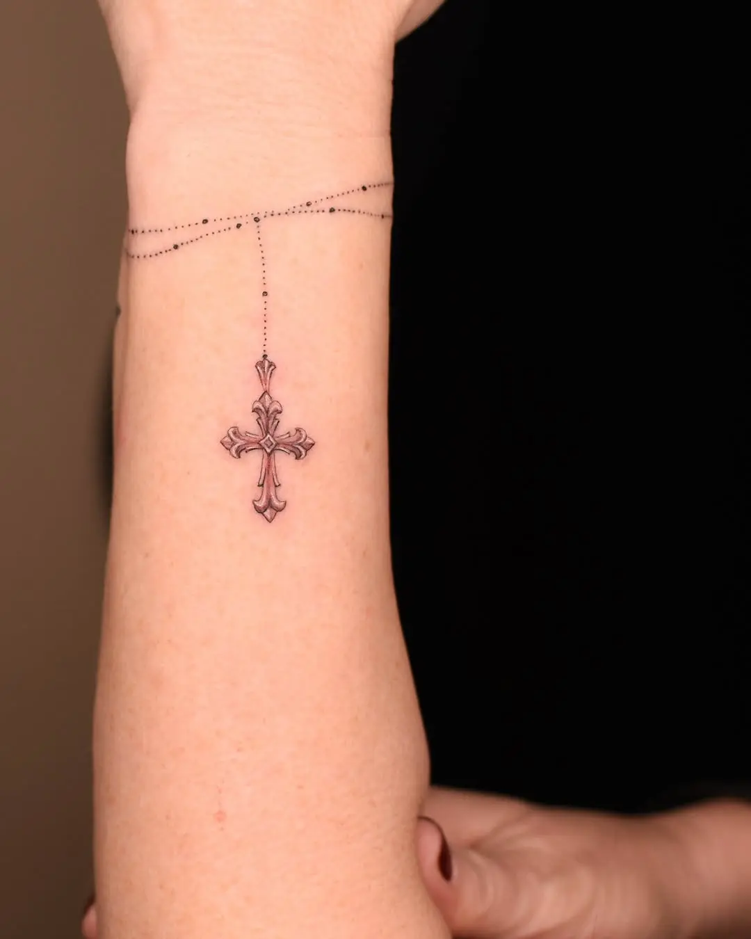 Elegant rosary tattoo with intricate cross design