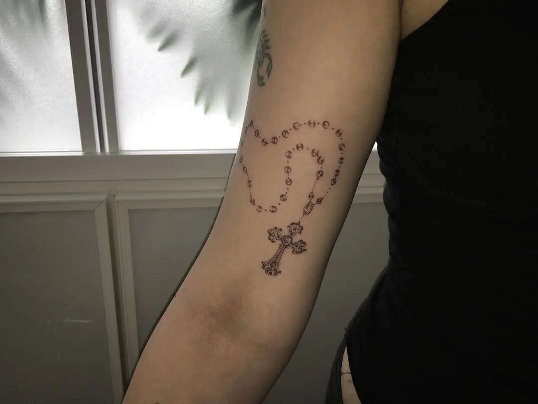 Elegant rosary tattoo showcasing spiritual devotion