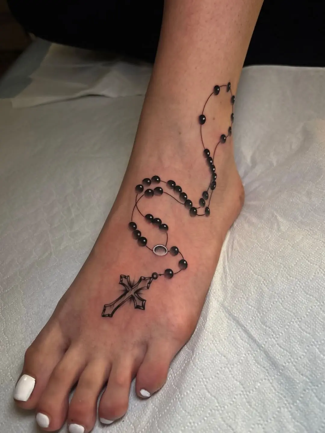 Elegant Rosary Tattoo Gracing the Ankle
