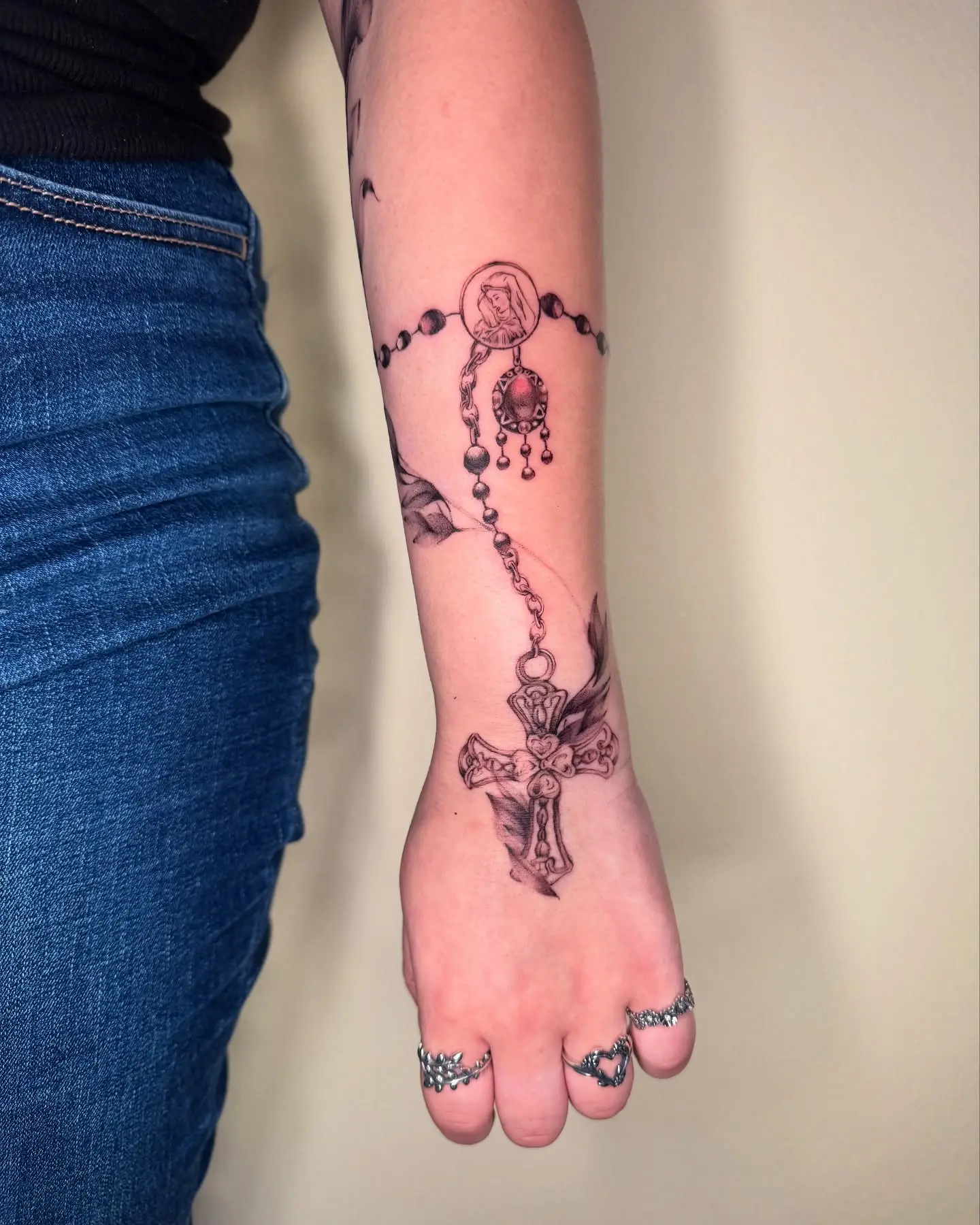 Intricate rosary tattoo on forearm design