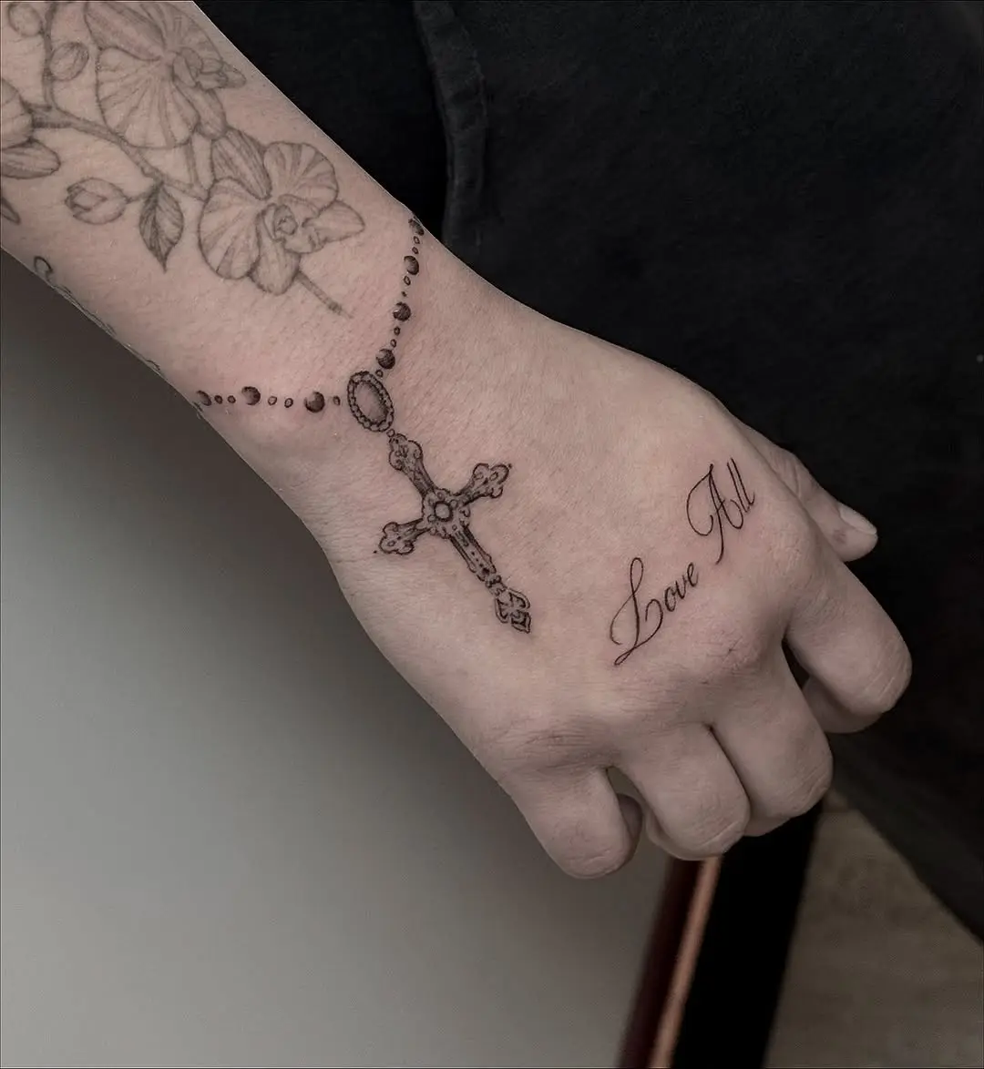 Elegant rosary tattoo design on hand