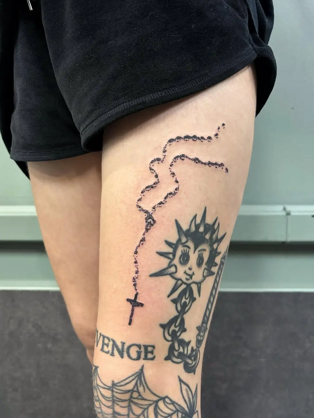 Graceful rosary tattoo design with cross