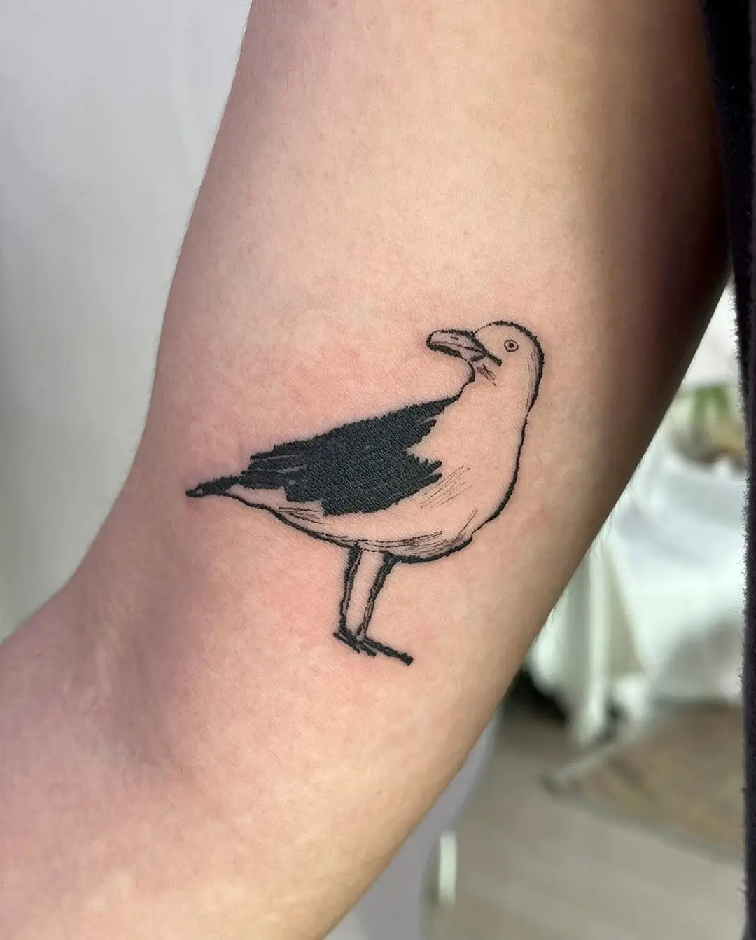 Charming seagull tattoo with minimalist design