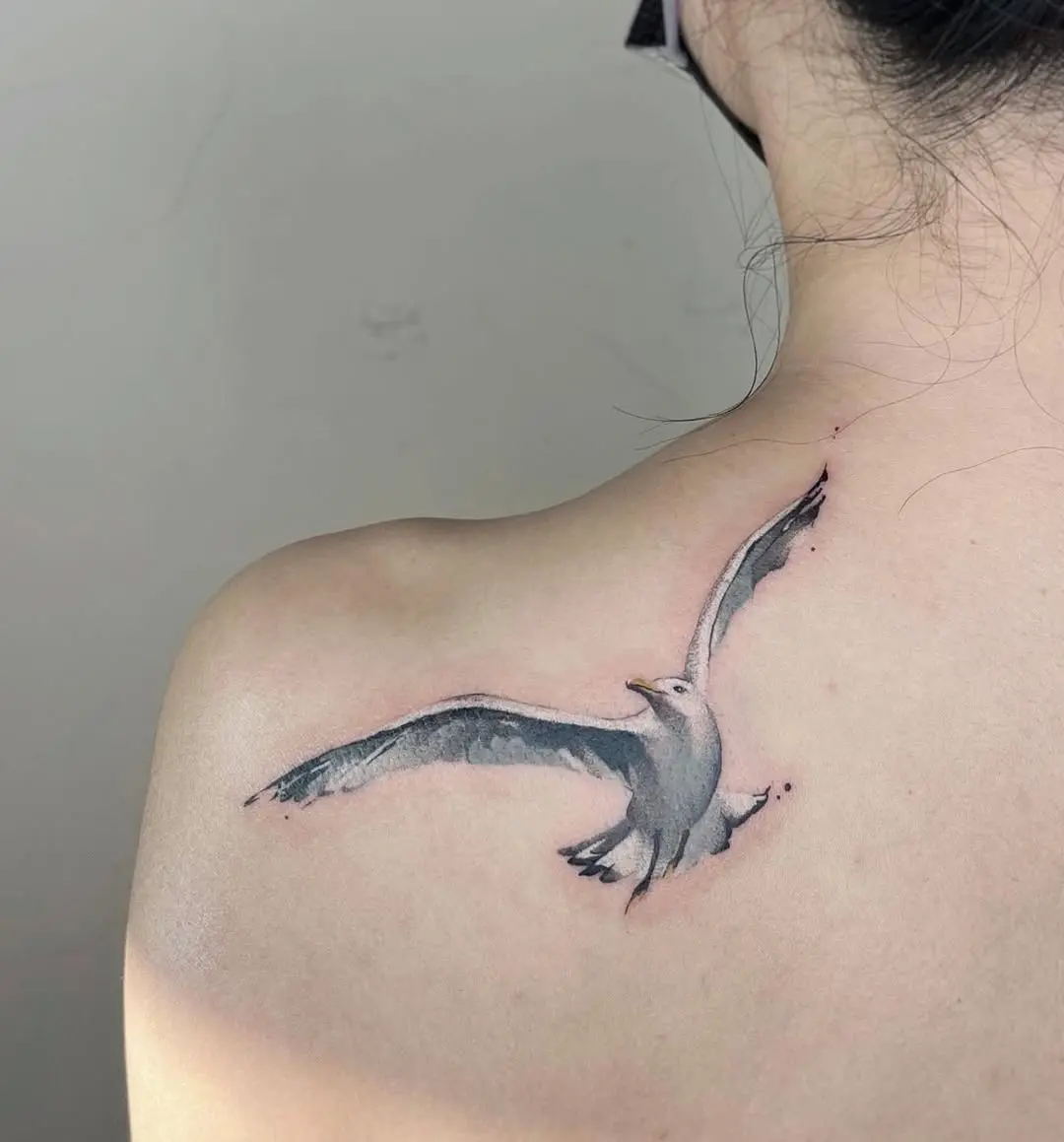 Elegant seagull tattoo in mid-flight